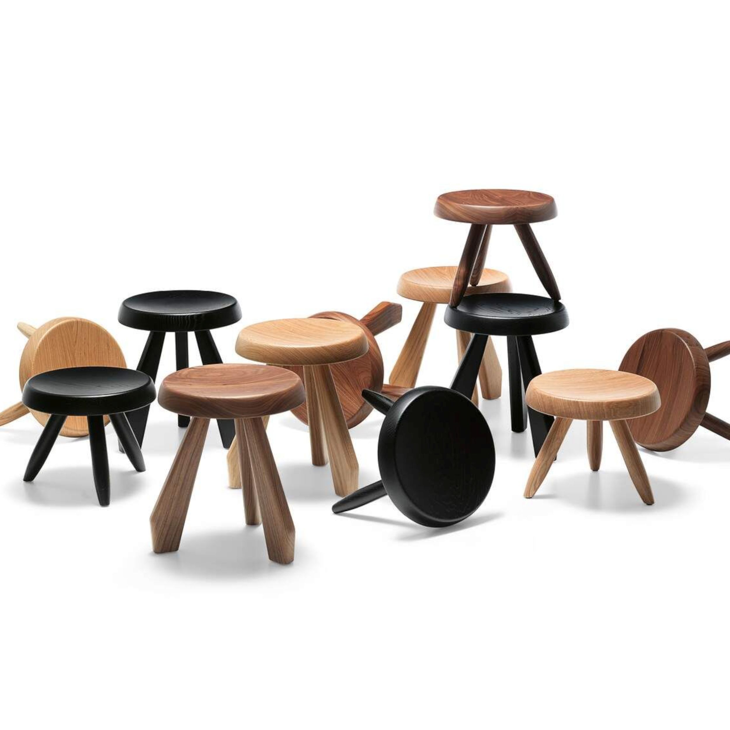 Hocker Tabouret Berger von Cassina in Nussbaum als Gruppenbild mit anderen Hockern und Tischen und unterschiedlichen Hölzern und Farben.