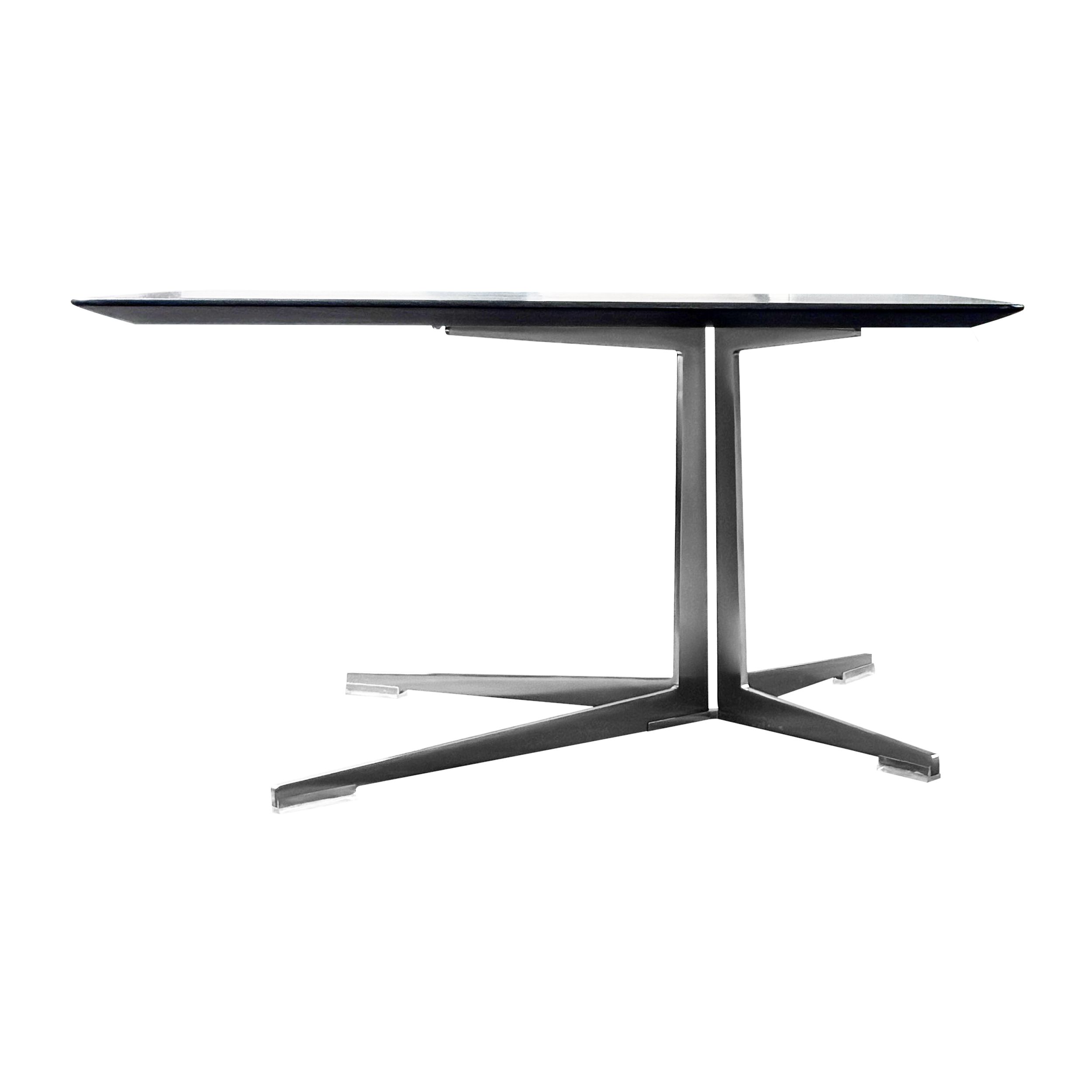 Ein quadratischer Couchtisch mit dunkler Holzplatte und sternförmigen Metallfuß, Modell Fly von Flexform, in seitlicher Ansicht vor einem weißen Hintergrund.
